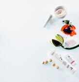 Various toiletries, hawthorn, flower on white background, elevated view