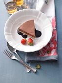 Chocolate terrine with mascarpone cheese, chocolate sauce and strawberries on plate