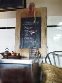 Wooden board with blackboard on wall in rural kitchen