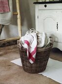 Clothes in woven basket for laundry