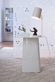 Frog statue and vase with illuminated lamp on white table
