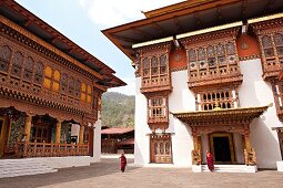 Monks in courtyard of Punakha monastery, Bhutan