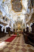 People in Rococo style chapel in Regensburg, Bavaria, Germany