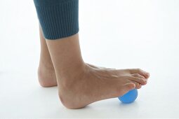 Close-up of feet grabbing rubber ball