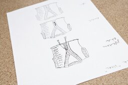 Close-up of drawing of knitted vest on white paper