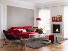 Wohnzimmer in Rot und Grau mit Sofa und Kamin