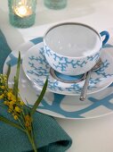 Porcelain cup and saucer in turquoise and white colour