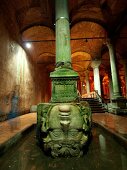 Enormous Basilica Cistern Medusa head pillar in water, Istanbul, Turkey