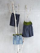 Denim skirts and shorts with moss on branches
