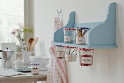 Shelf board with hanging spice jar on wall