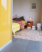Yellow wardrobe as room divide in modern town house