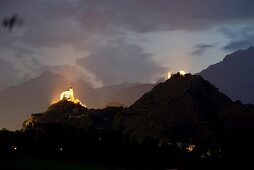 View of cityscape with two castle at dusk in Valais, Switzerland