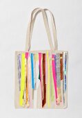 Close-up of colourful striped cotton bag on white background