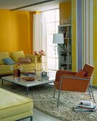 Living room with yellow walls, colourful furnishings, bookcase and sofa