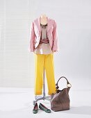 Pink blazer and yellow silk pants on clothes stand