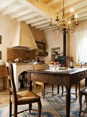 Kitchen-dining room with old oak table and farmhouse chairs in Tuscan country house