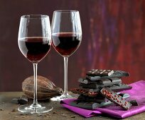 Two glasses of red wine and stack of chocolate