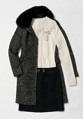 Tweed jacket with black cardigan and skirt on white background