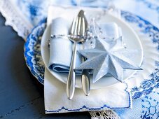 A place setting decorated for Christmas in blue and white