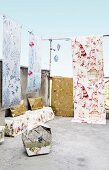 Various wallpaper strips hanging on a terrace