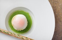 Egg and smoked eel with sauce on plate