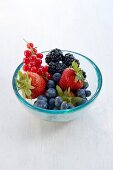 Various fresh berries in glass bowl