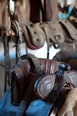 Close-up of horse saddles, Maremma, Italy