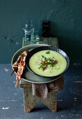 Cream of Brussels sprouts and celery soup served with lamb skewers