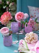 Fresh roses in floral patterned vases