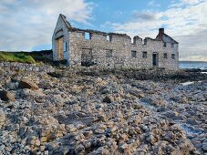 View of Kelpstore ruins surrounded with rocks on Rathlin Island coast, Ireland, UK