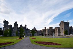 View of Ashford Castle with pavement and garden, Ireland, UK