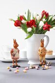 White jug with tulips and bunny figurines on side