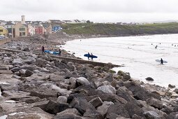 View of surfers and rocks at Lahinch Co Clare beach, Ireland, UK