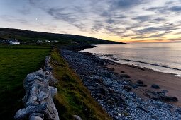 View of Fanore beach and horizon over sea at dusk, Ireland, UK