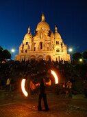 Spectators watching street play in front of Sacre Coeur at dusk, Paris, France