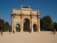 People walking in front of Arc de Triomphe on Place Charles de Gaulle in Paris, France