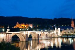 Illuminated Karl-Theodor-Bridge at evening in Heidelberg, Germany