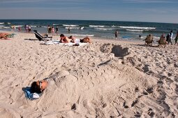 People relaxing on beach, New York, USA