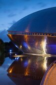 Symmetrical reflection of Atlantic Hotel Universum at night, Bremen, Germany