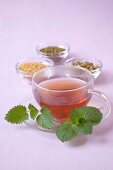 Cup of medicinal tea on glass saucer