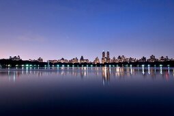 View of Jacqueline Kennedy Onassis Reservoir in Central Park at dusk, New York, USA