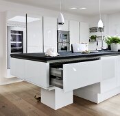 View of modern kitchen with white furniture and cutlery drawer