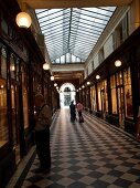 People passing through Gallery Vero Dodat in Paris, France