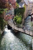 Boy standing on bridge in Augsburg, Bavaria, Germany