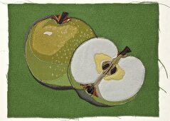 Apple shape embroidered on green cloth
