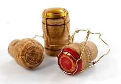 Three champagne corks on white background