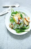 Spinach salad with rice, fennel and lettuce on plate