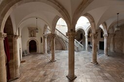 Tourists walking in portico of Rector's Palace, Dubrovnik, Croatia