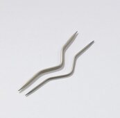 Close-up of two cable needles on white background