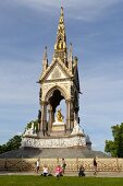 People in Kensington Gardens in Albert Memorial, London, UK